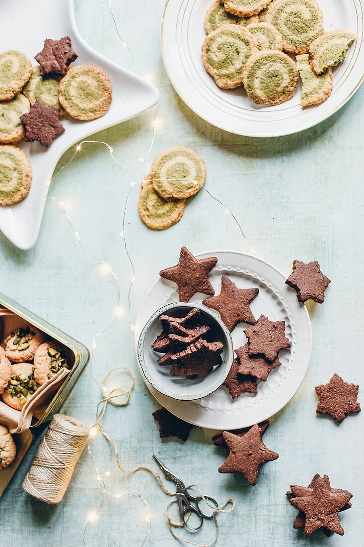 Assorted Christmas biscuits on plates and in tins