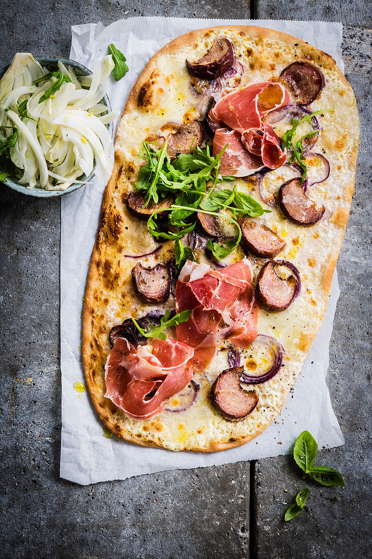 White pizza with mushrooms, serano ham and mozzarella cheese