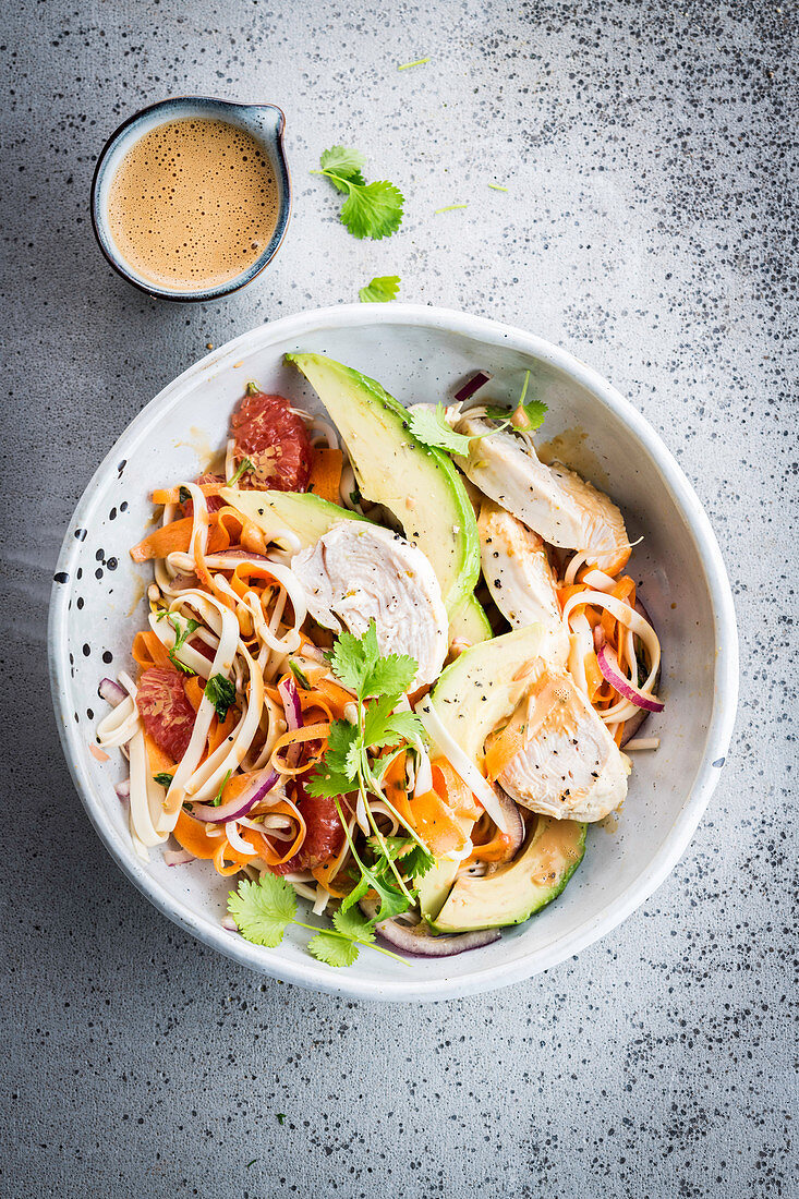 Pasta bowl with poached chicken, avocado and pink grapefruit