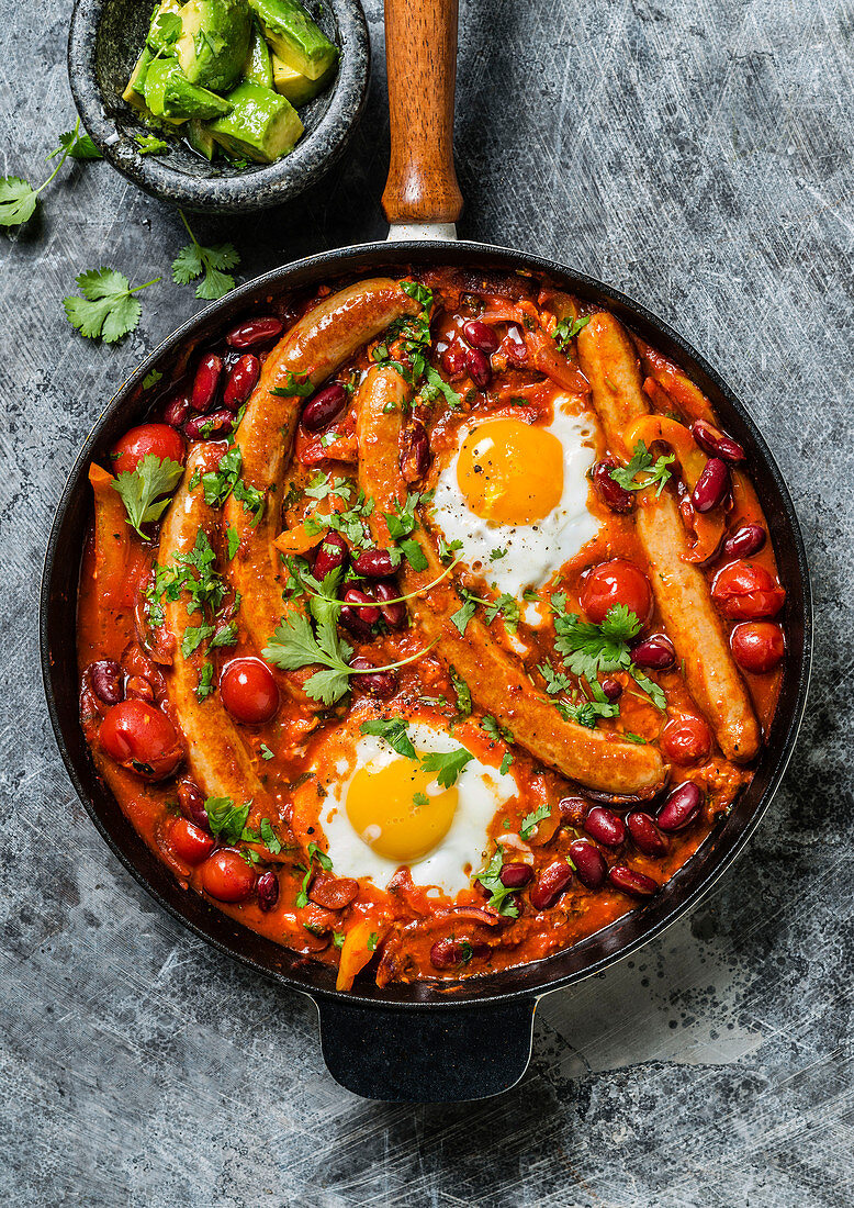 Shakshuka with chicken sausages and fried eggs