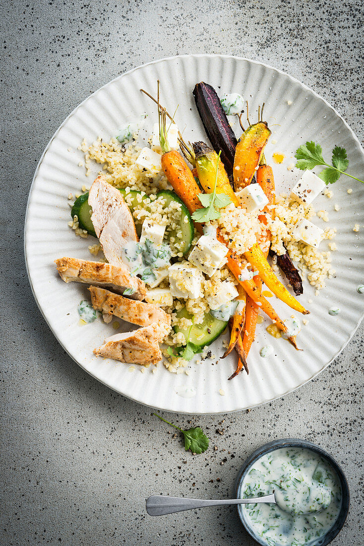 Tandoori chicken with couscous, courgette, colourful carrots and feta