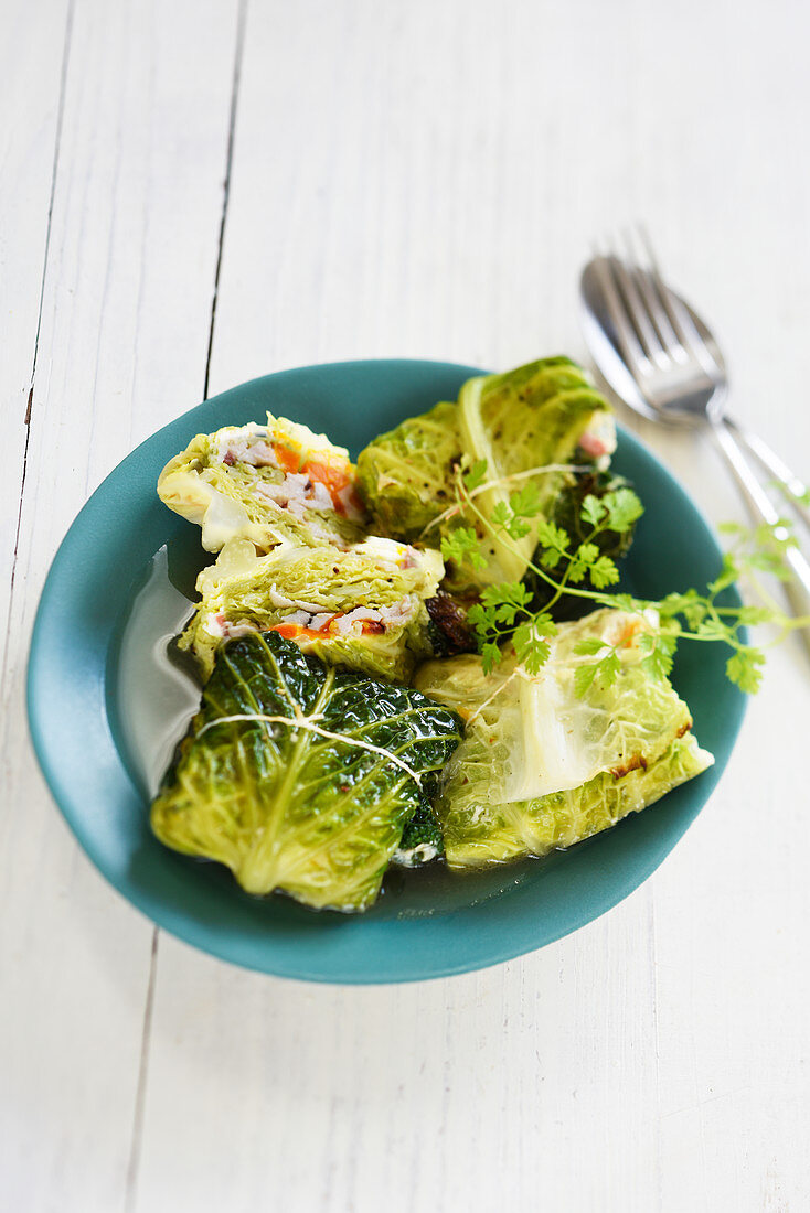 Cabbage parcels stuffed with chicken, bacon and carrots