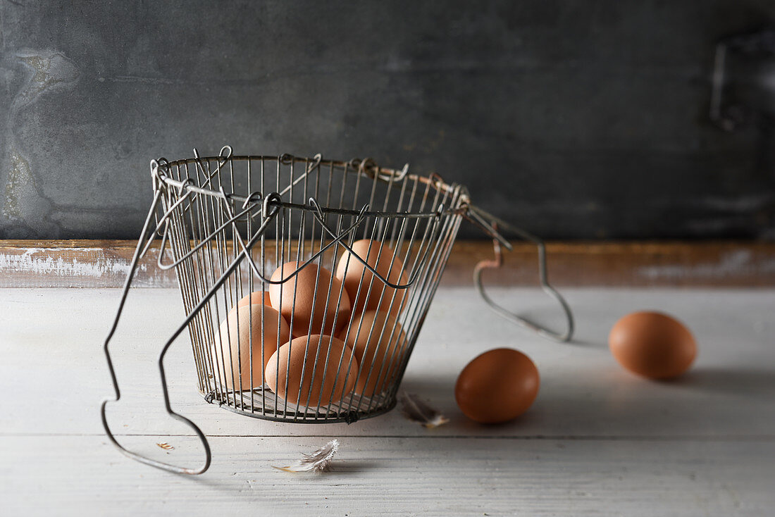 Brown chicken eggs in a wire basket