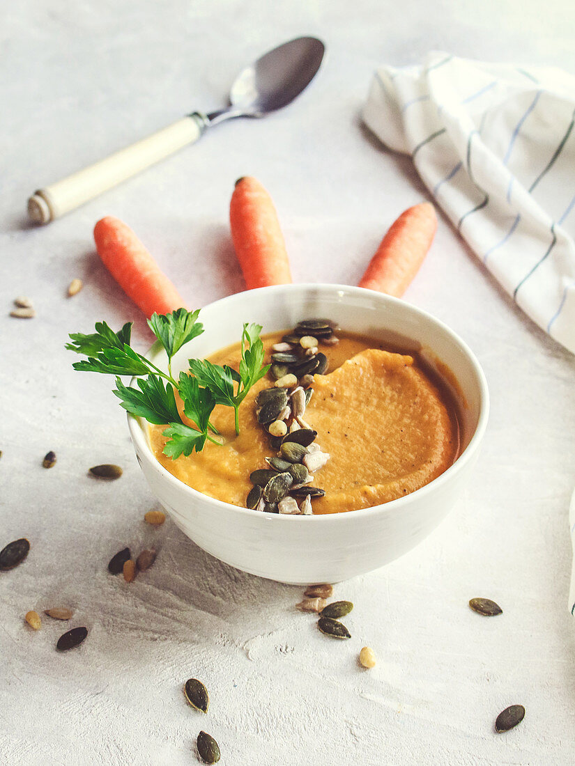 Carrot and butternut squash soup topped with mixed seeds