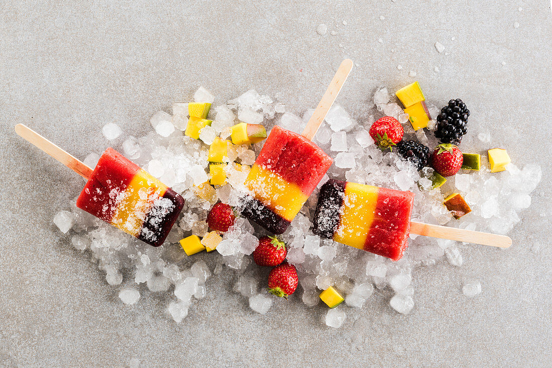Popsicles with red fruits and mango