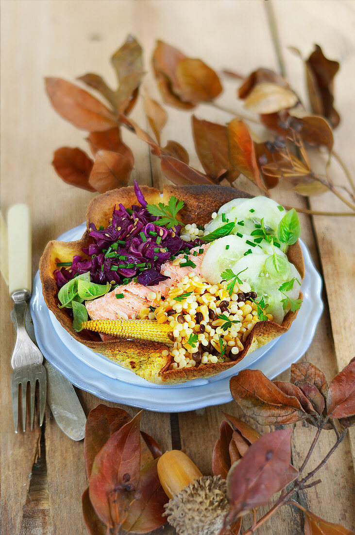 Winter salad with salmon, red cabbage, cucumber and cereals
