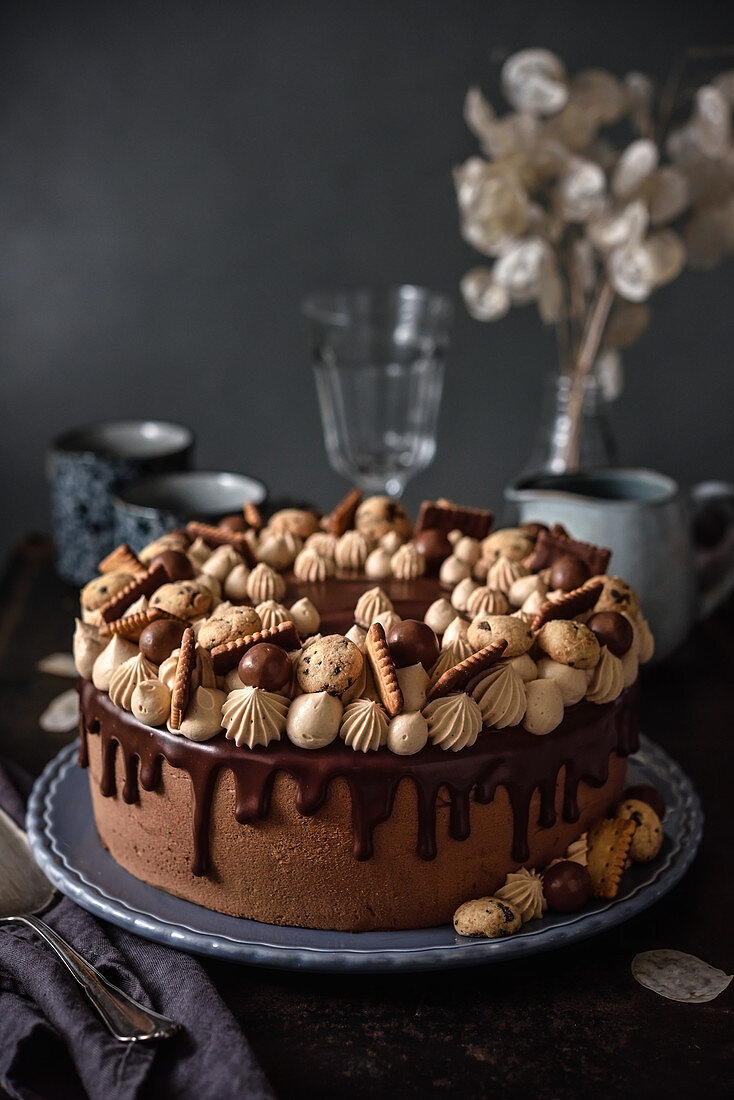 Festive chocolate cake decorated with confectionery and biscuits