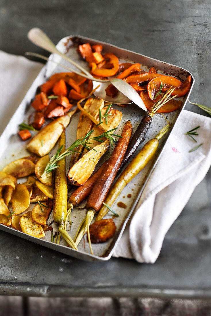 Winter vegetables on a tray with honey and rosemary