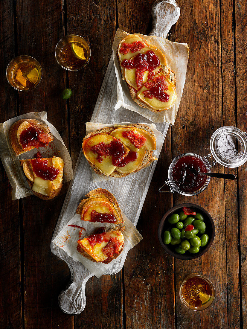 Spreads of melted cheese, tomato sauce and red fruit jam