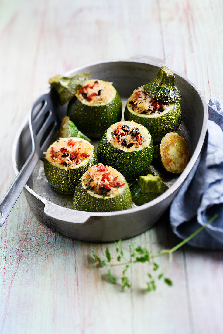 Zucchini stuffed with rice, tomato and olives