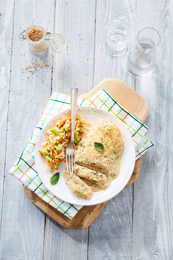 Schnitzel with cream sauce and a vegetable garnish