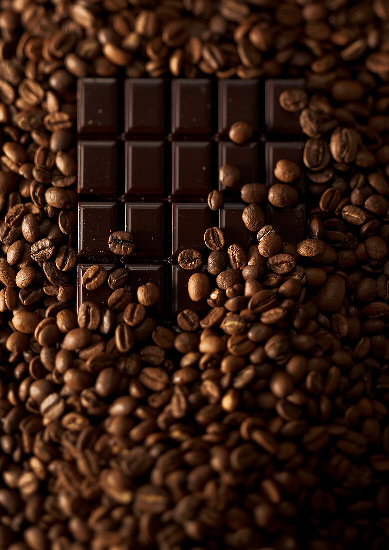 Composition of coffee beans with a dark chocolate bar