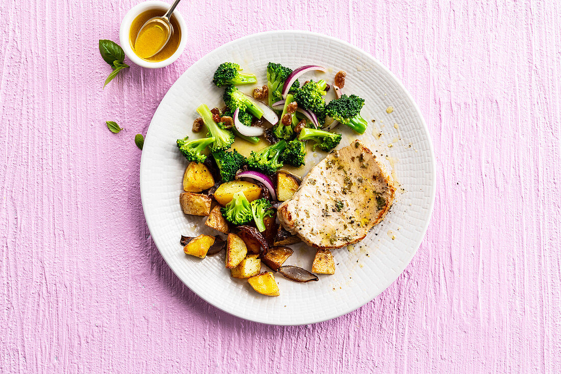 Slice of pork roast with broccoli and fried potatoes