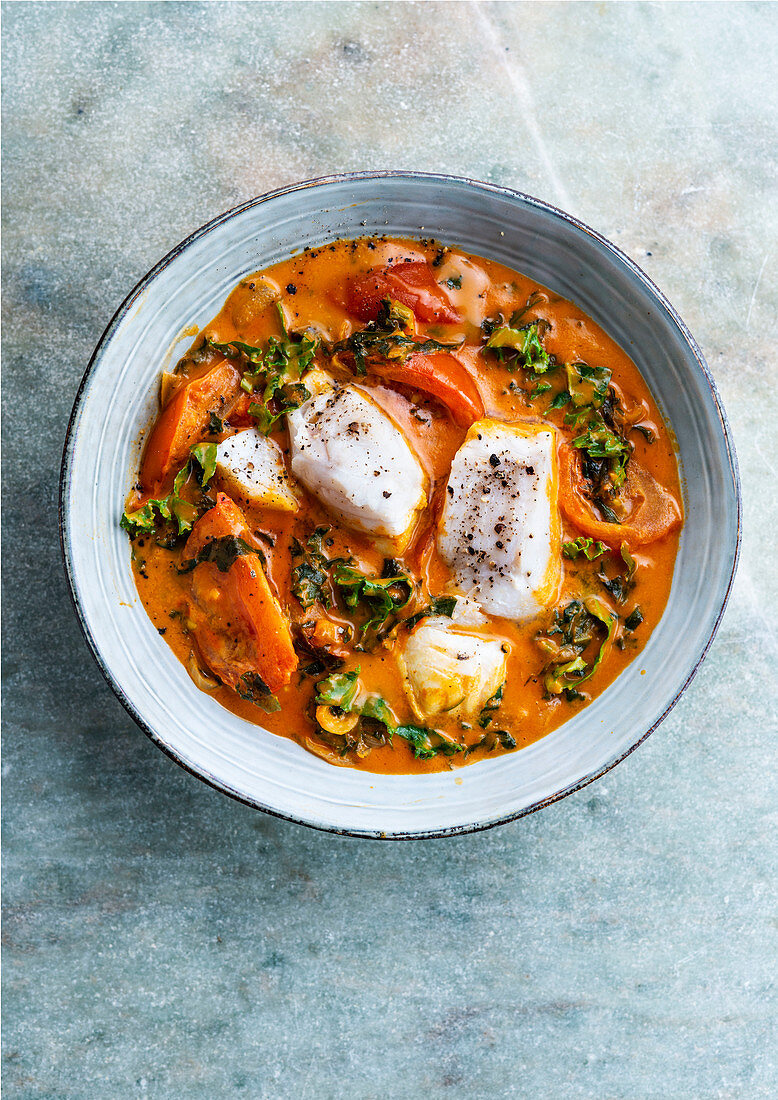 Fish in coconut milk with tomato and kale