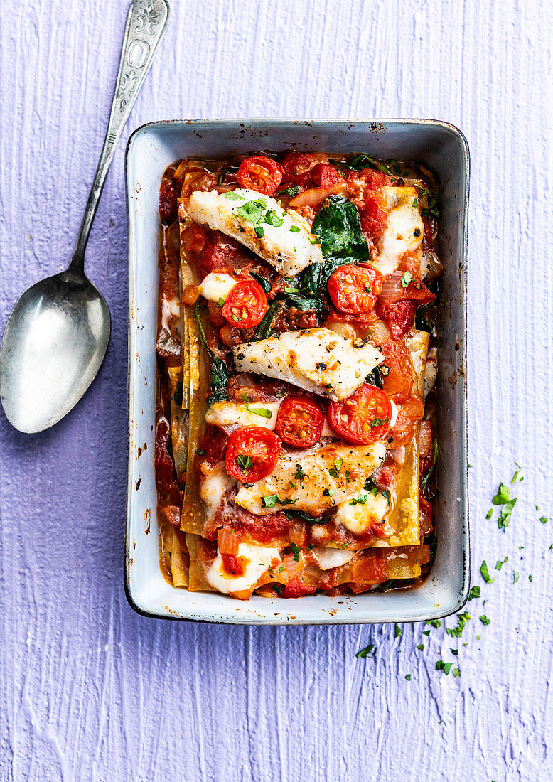 Lasagna with fish, tomato, spinach and mozzarella cheese sauce
