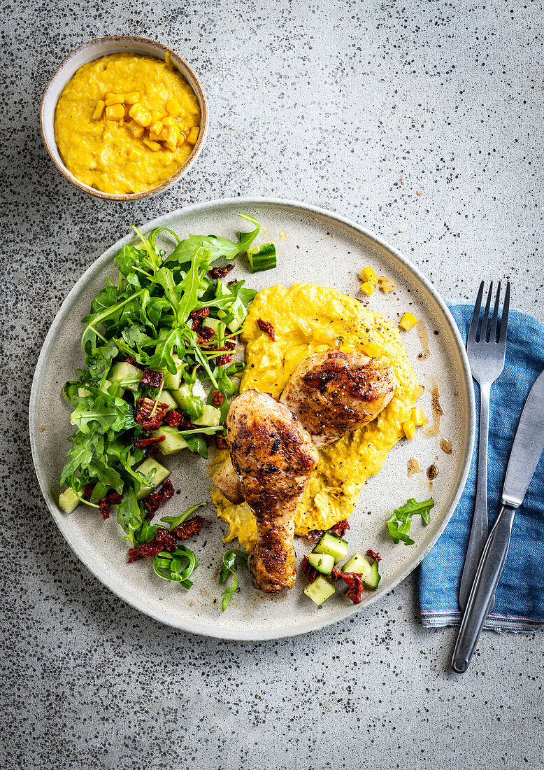 Grilled chicken leg with mashed corn and salad