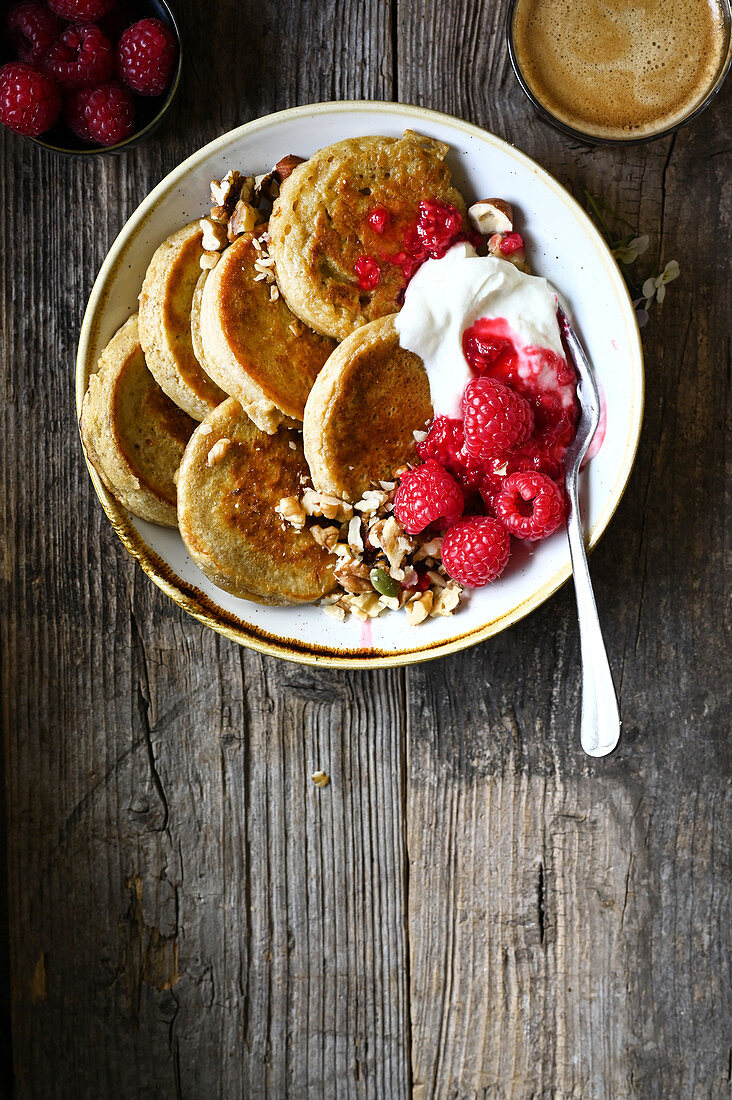 Oat pancakes with dried fruit,nuts and raspberries