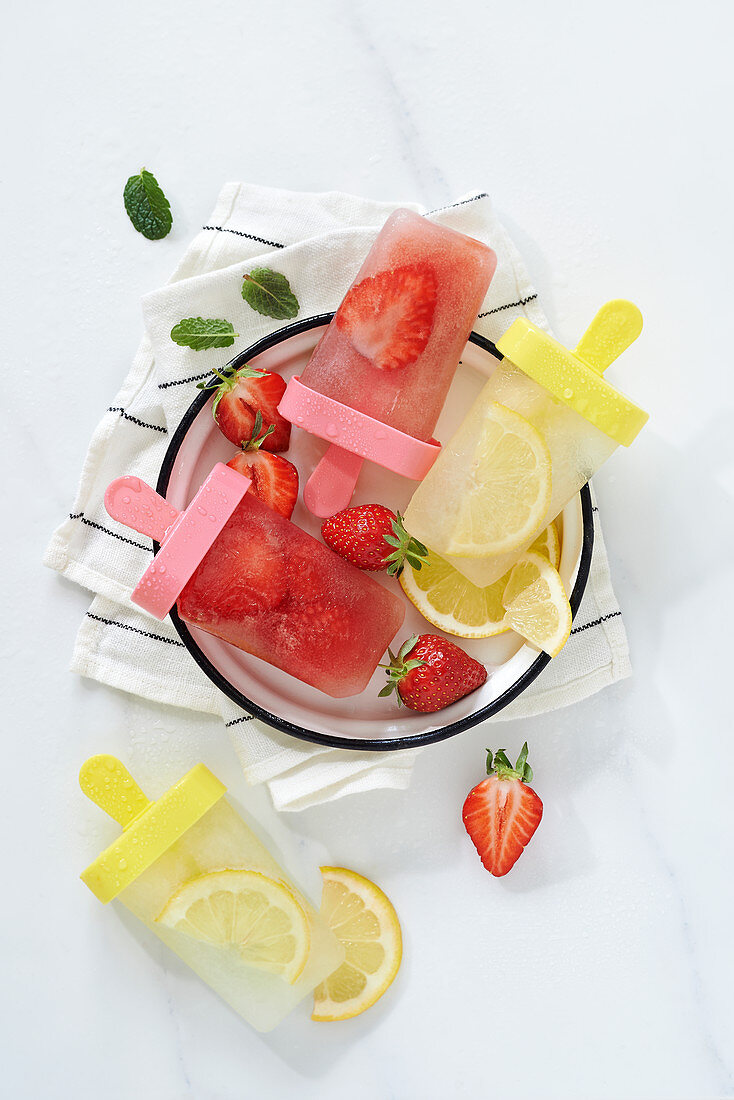 Lemon and strawberry iced lollipops