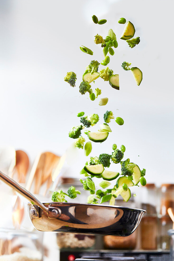 Pan frying and tossing green vegetables