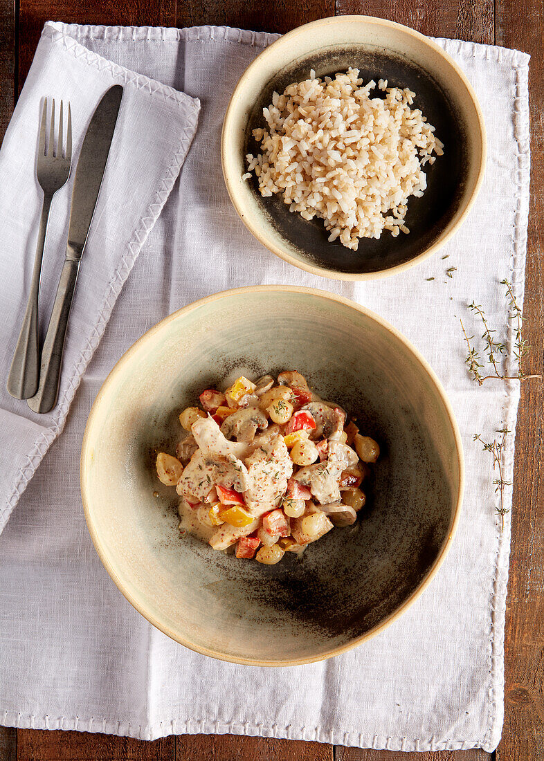 Chicken with chickpeas, peppers, mushrooms and mustard sauce served with rice