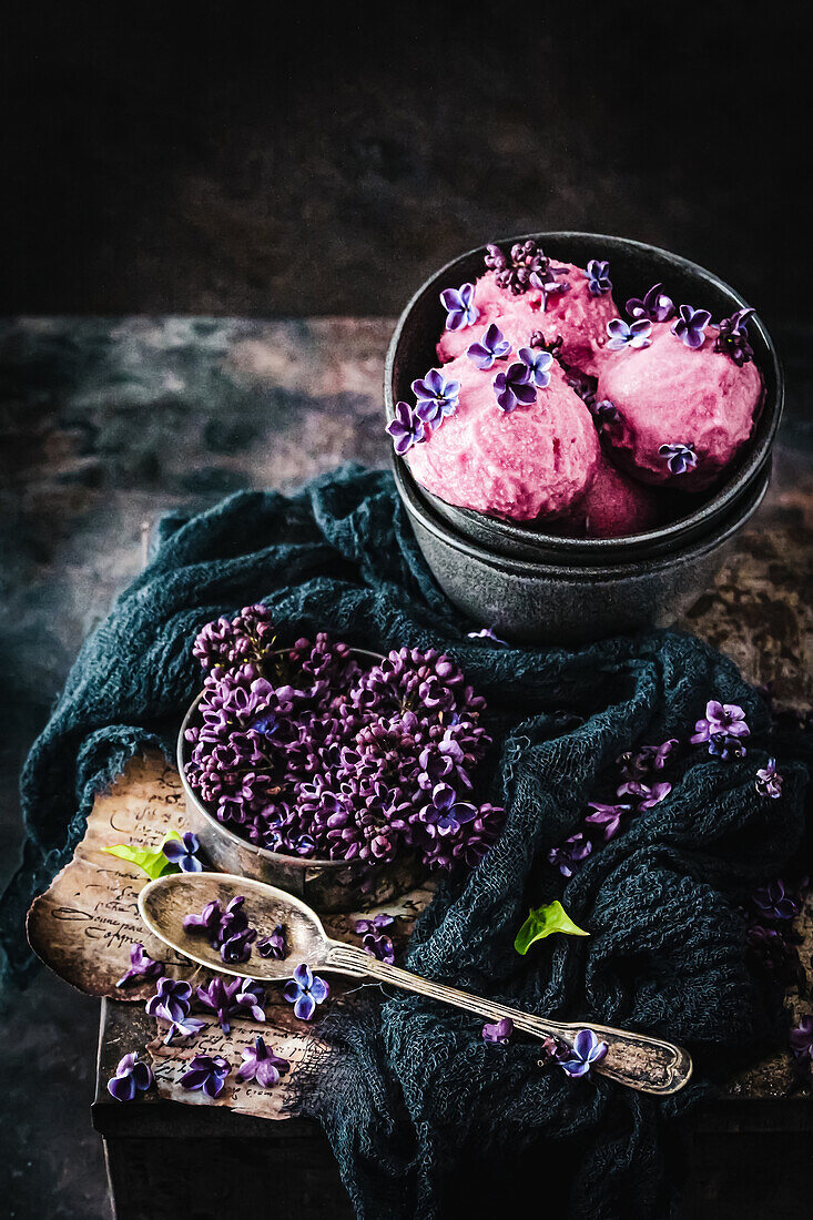 Raspberry ice cream scoops with lilac flowers