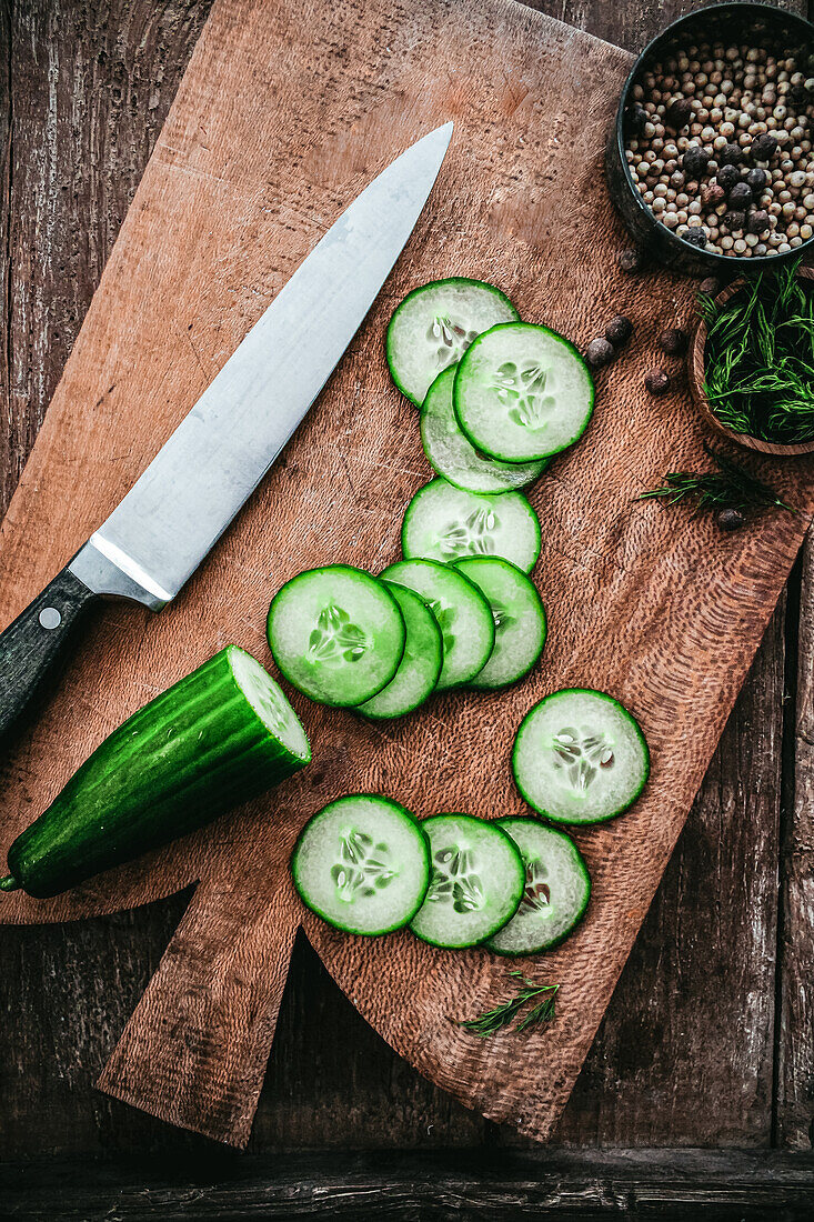 Sliced cucumber on wooden board