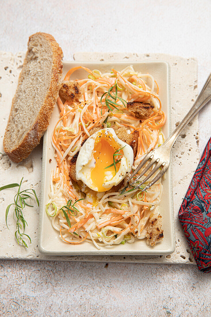 Coleslaw with a waxy egg and bread