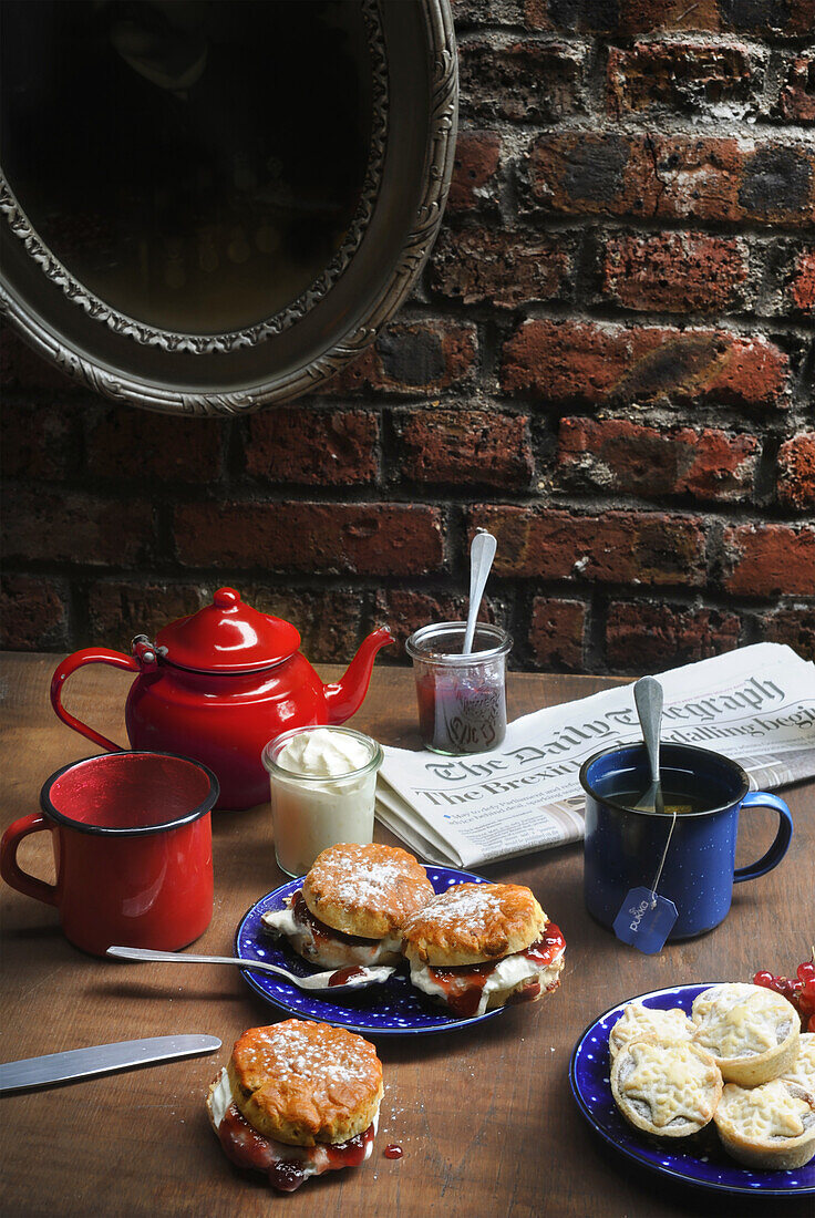 English breakfast table with scones, jam, clotted cream, and tea