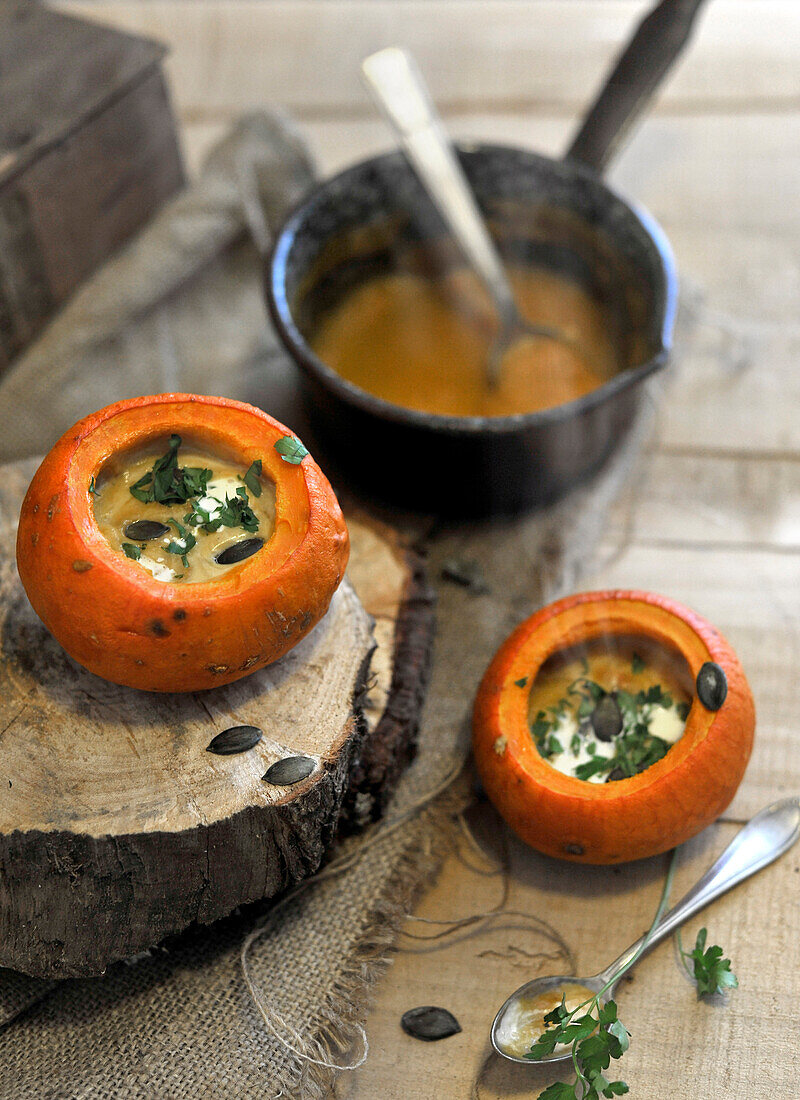 Pumpkin soup served in small hollowed out pumpkins