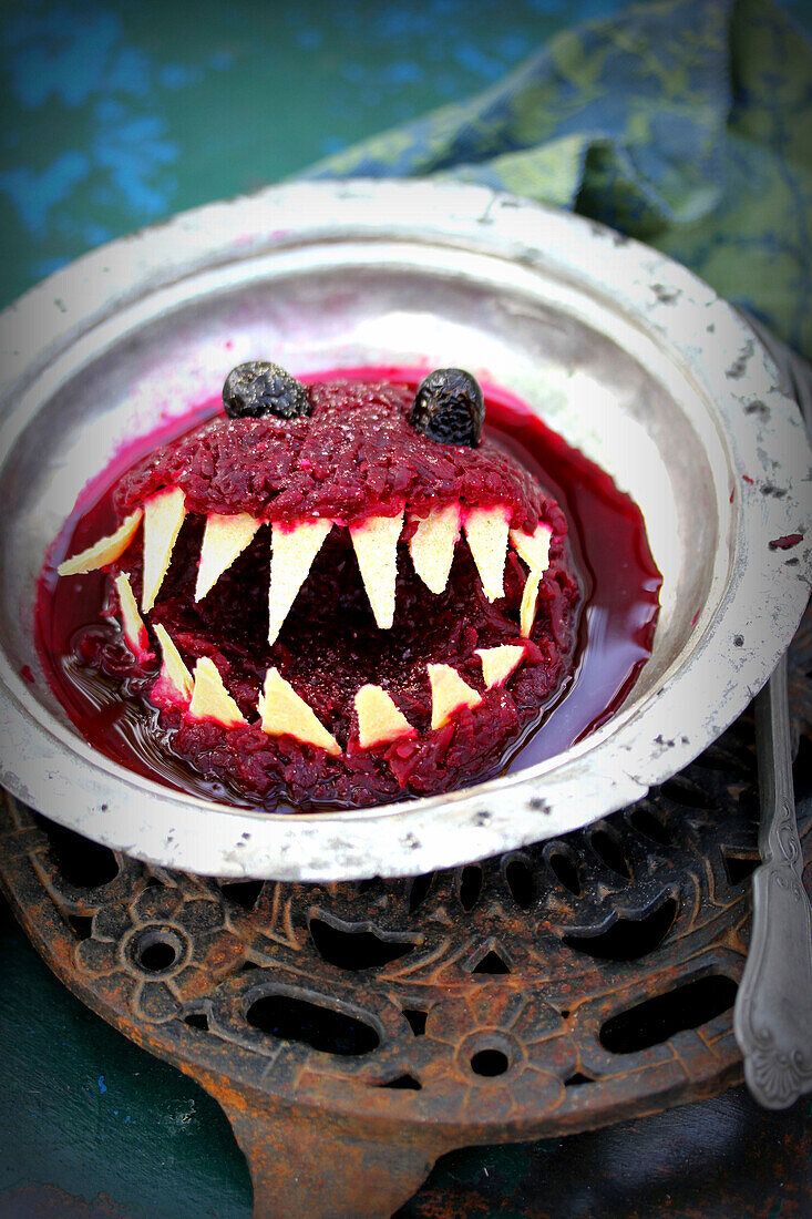 Pita bread with beetroot salad in the shape of a monster's head for Halloween