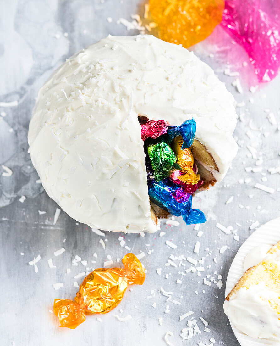 Dome cake with frosting and filled with sweets