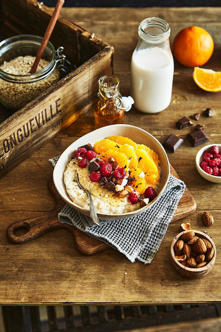 Orange porridge with dark chocolate, almonds and raspberries