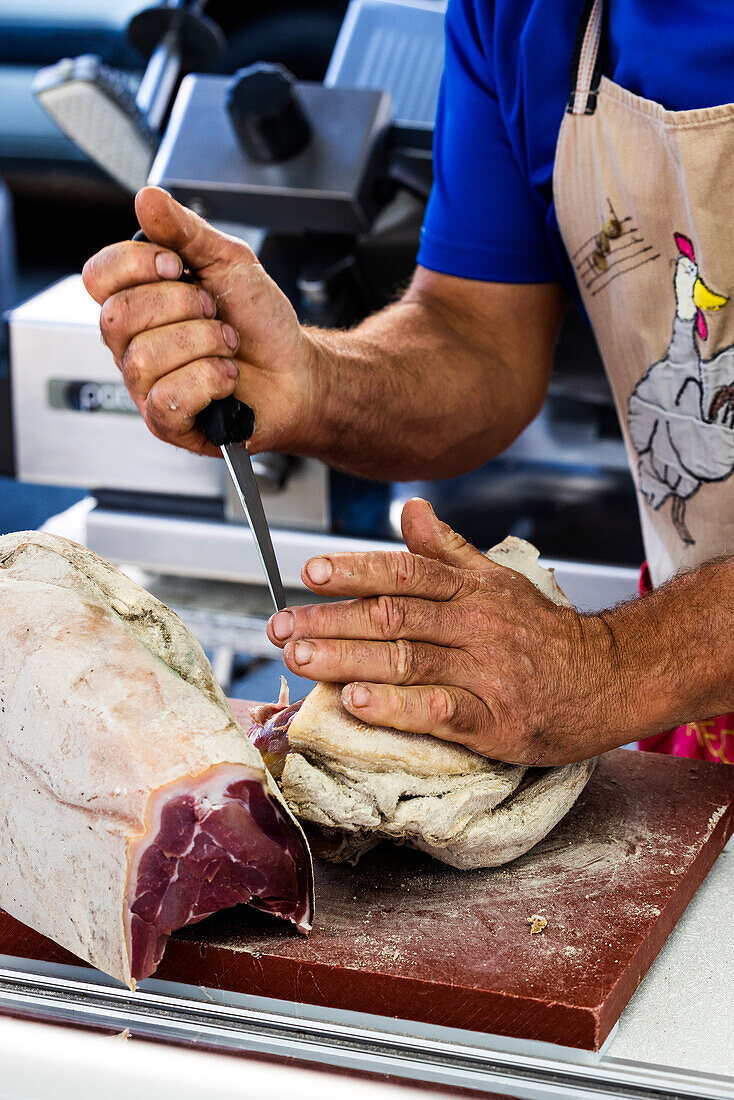 Butcher cutting meat