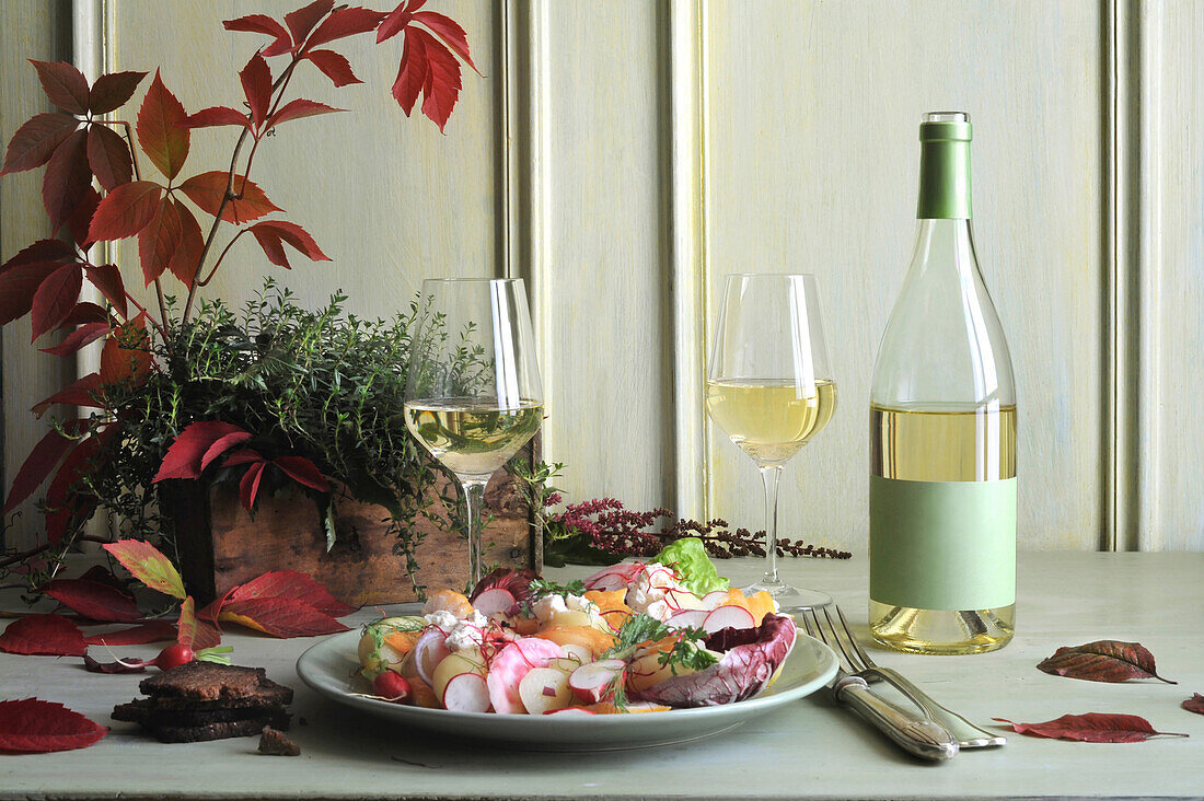 Lauwarmer Schellfischsalat mit Kartoffeln und einem Glas Weißwein