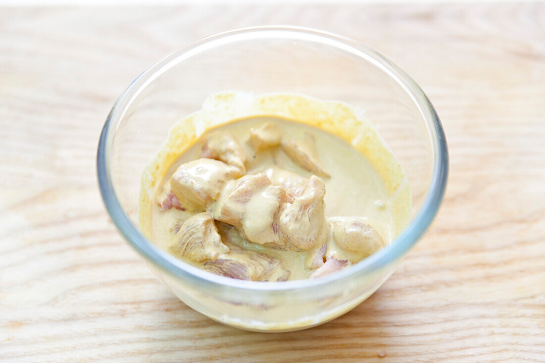 Poultry in a curry and coconut milk marinade for skewers