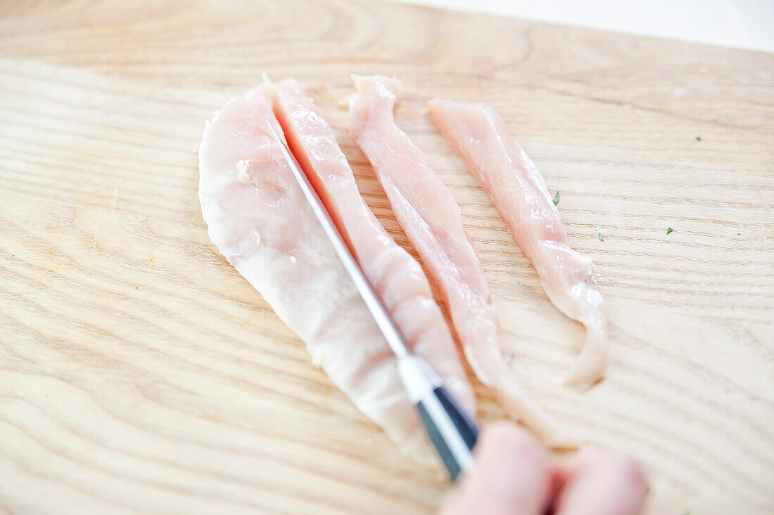 Cutting chicken into strips