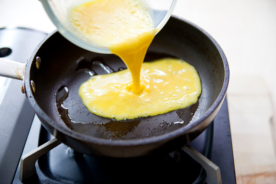 Preparing omelette: Pour batter into a pan