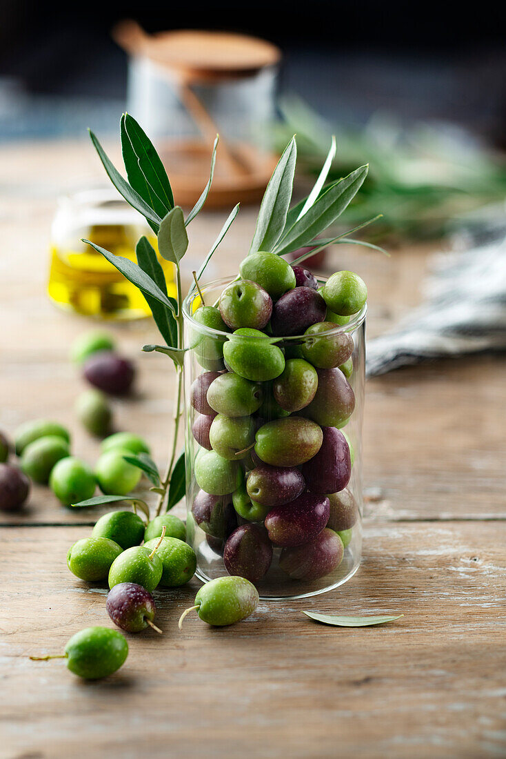 Freshly harvested olives in a glass jar