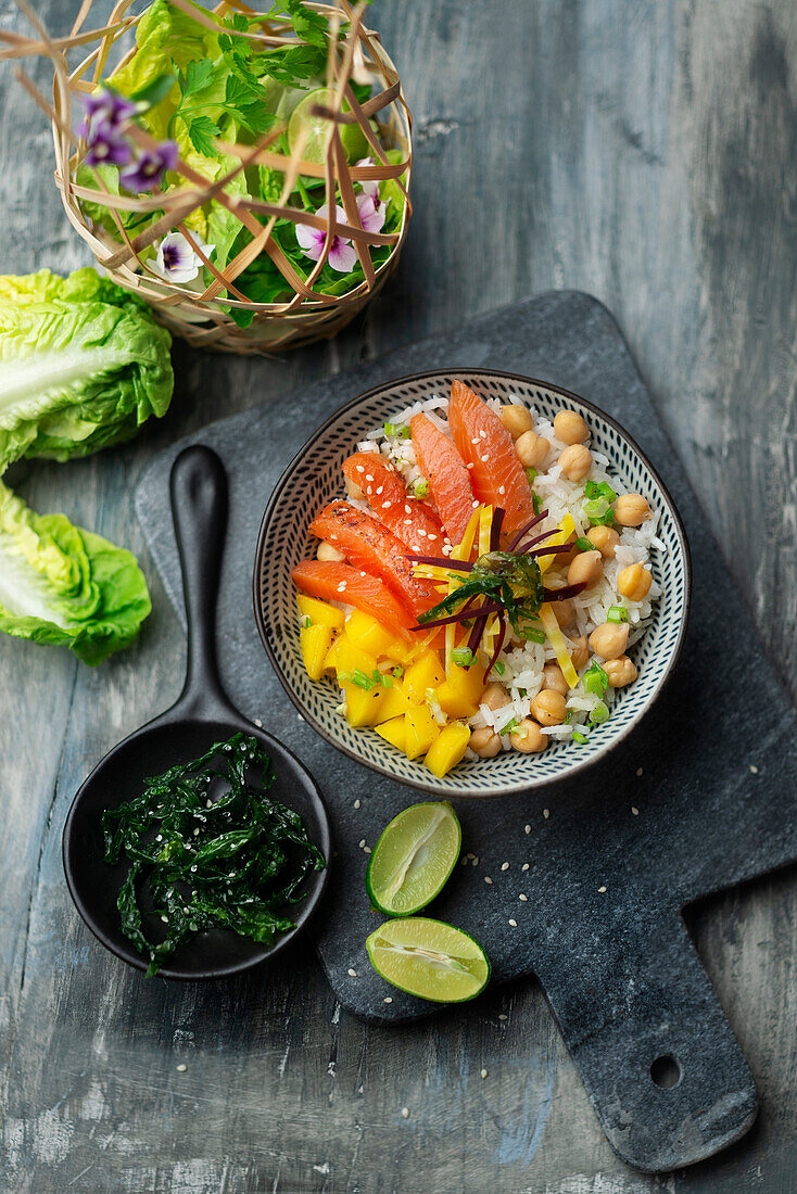 Poke bowl with salmon, mango, chickpeas, and rice