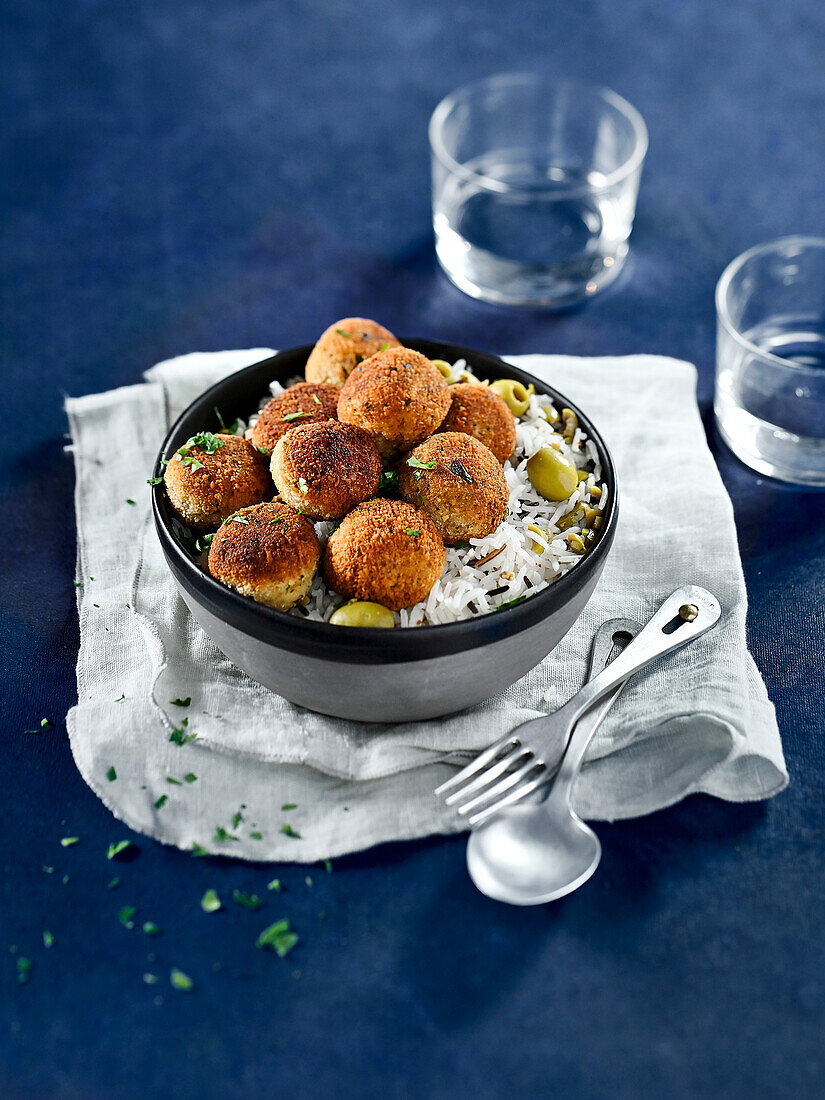 Tuna croquettes on lukewarm rice salad with olives