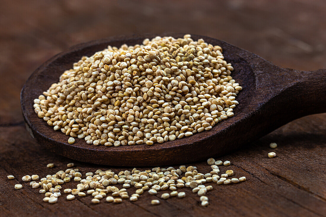 Quinoa grains on a wooden spoon