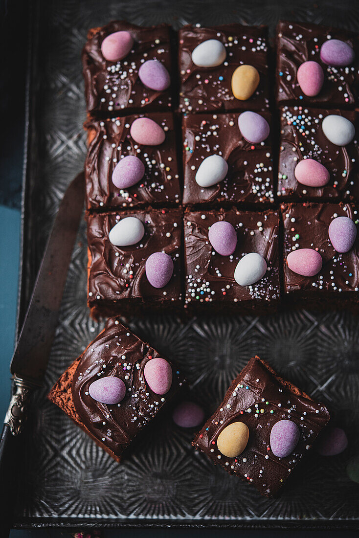 Chocolate cake on a tray decorated with sugar eggs for Easter