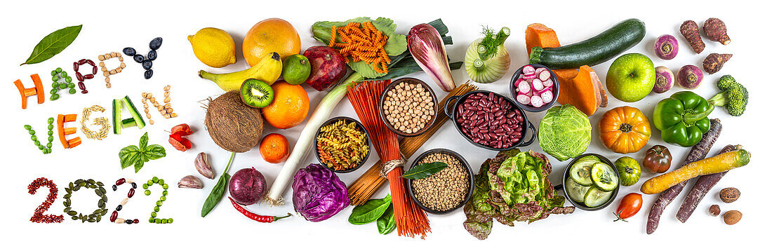 ‘Happy vegan 2022' next to fruit, vegetables and cereals