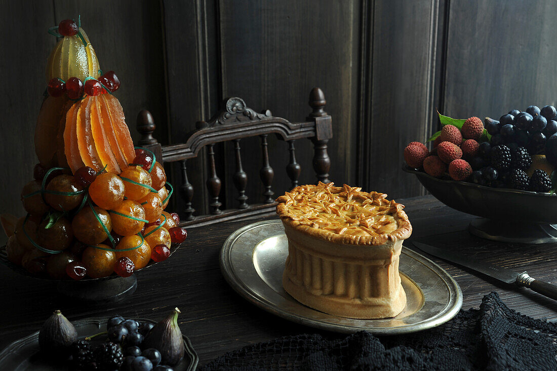 Pate, tart with candied fruit, and bowl of fresh fruit