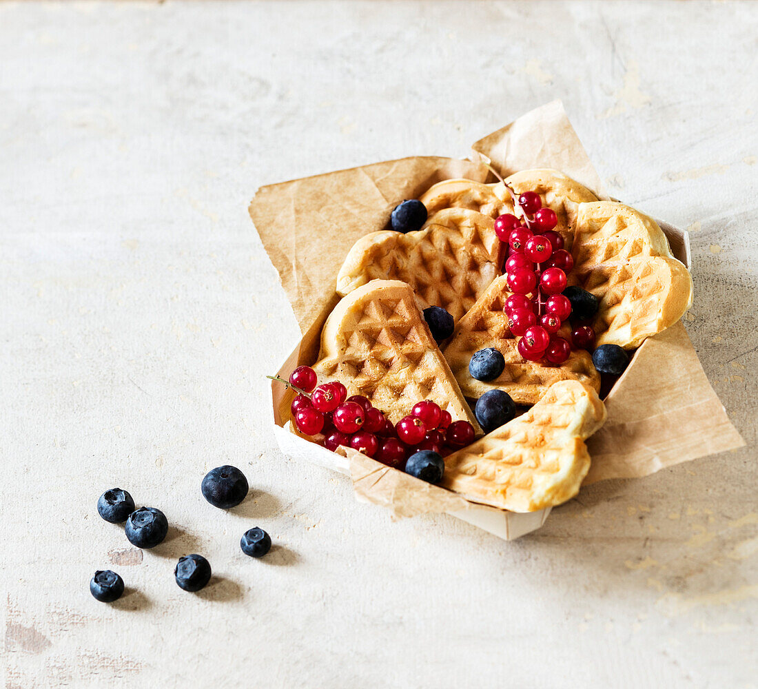 Heart-shaped waffles with fresh berries
