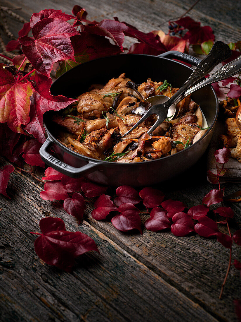 Poultry with wild mushrooms in a cast iron pot