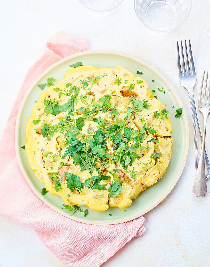Omelette with bacon, potatoes and herbs