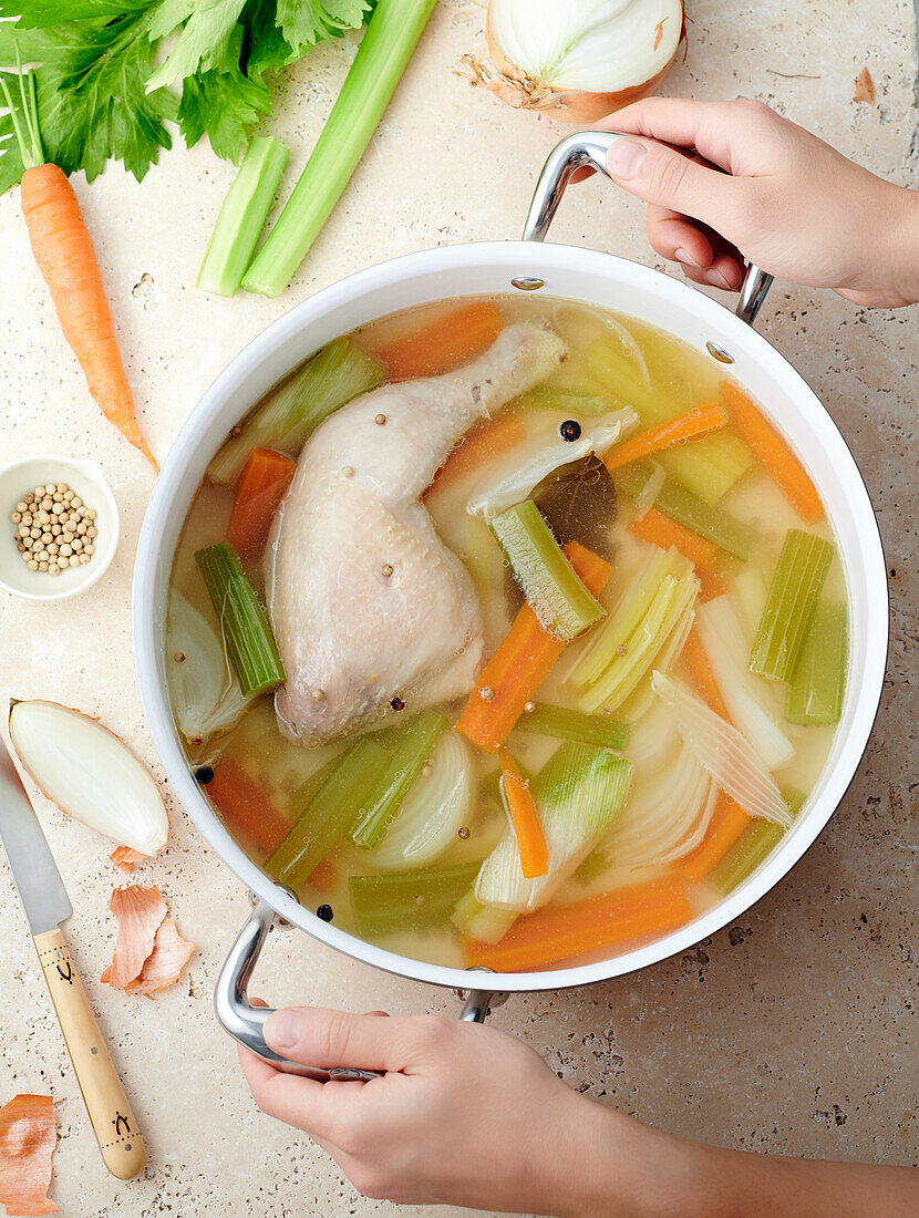 Vegetable broth with chicken in a pot