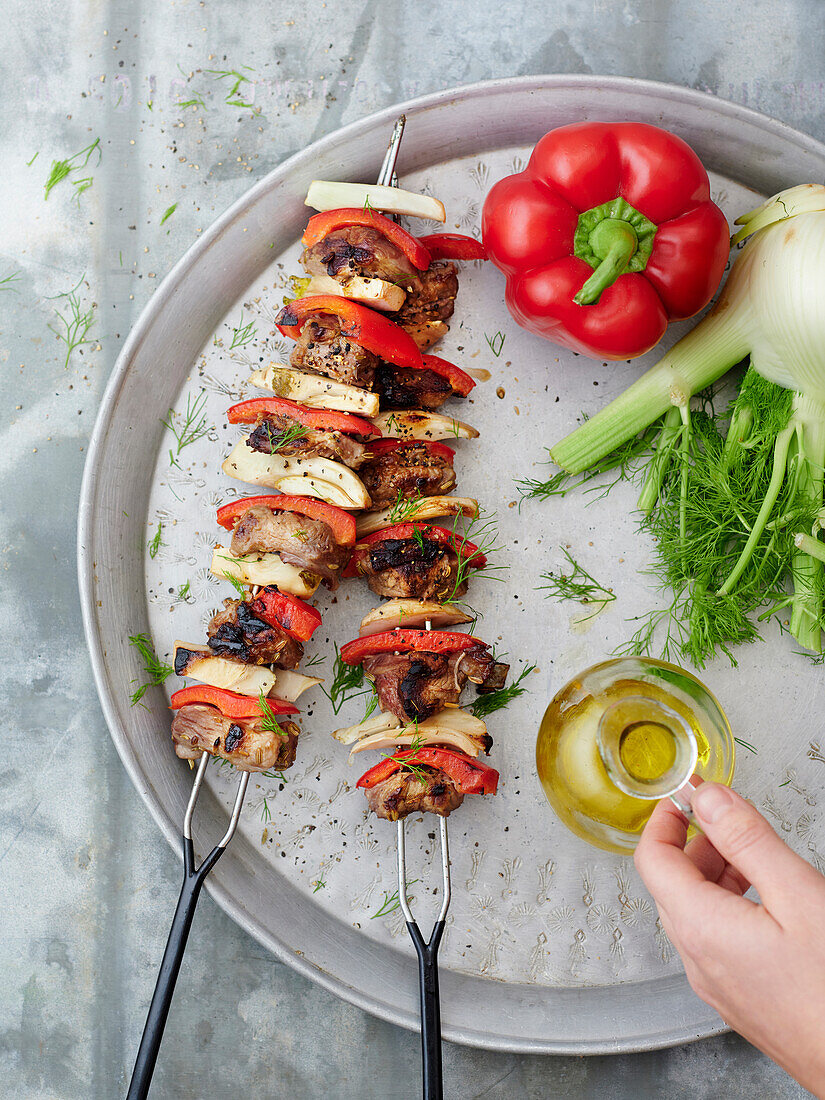 Lamb skewers with fennel and grilled peppers