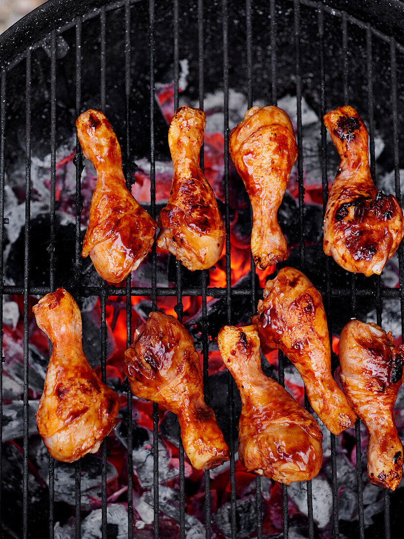 Chicken drumsticks grilling on the barbecue